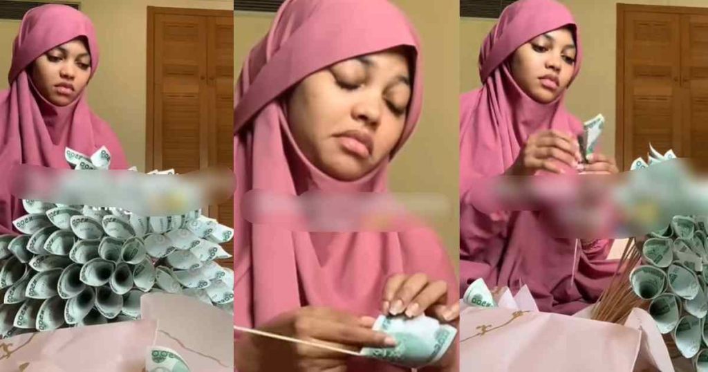  lady-shares-the-untold-reality-of-receiving-a-money-bouquet-as-she-struggles-to-unwrap-naira-notes-(video)