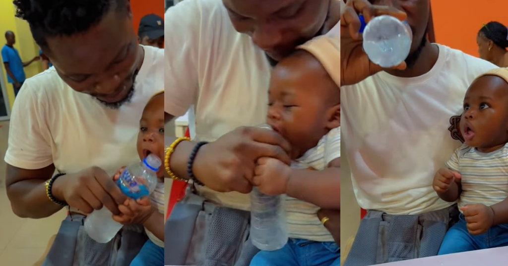 adorable-moment-a-toddler-attempts-to-imitate-his-father’s-drinking-method-by-grabbing-the-bottle-of-water-(watch)