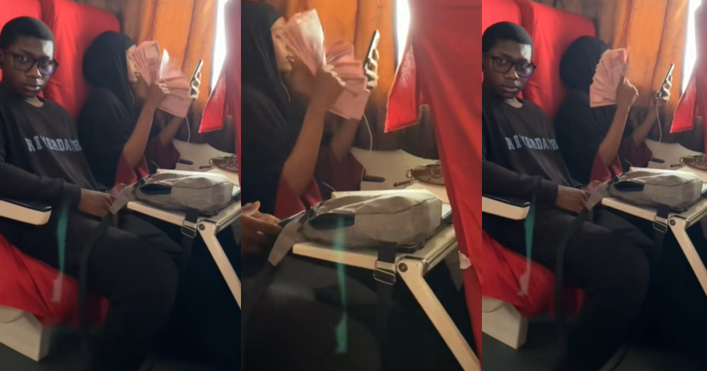 lady-flaunts-wealth,-fans-herself-with-₦200-mint-notes-inside-train-(video)